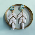 White polymer clay flower cluster hoop earrings with crystal-studded silver hoops
