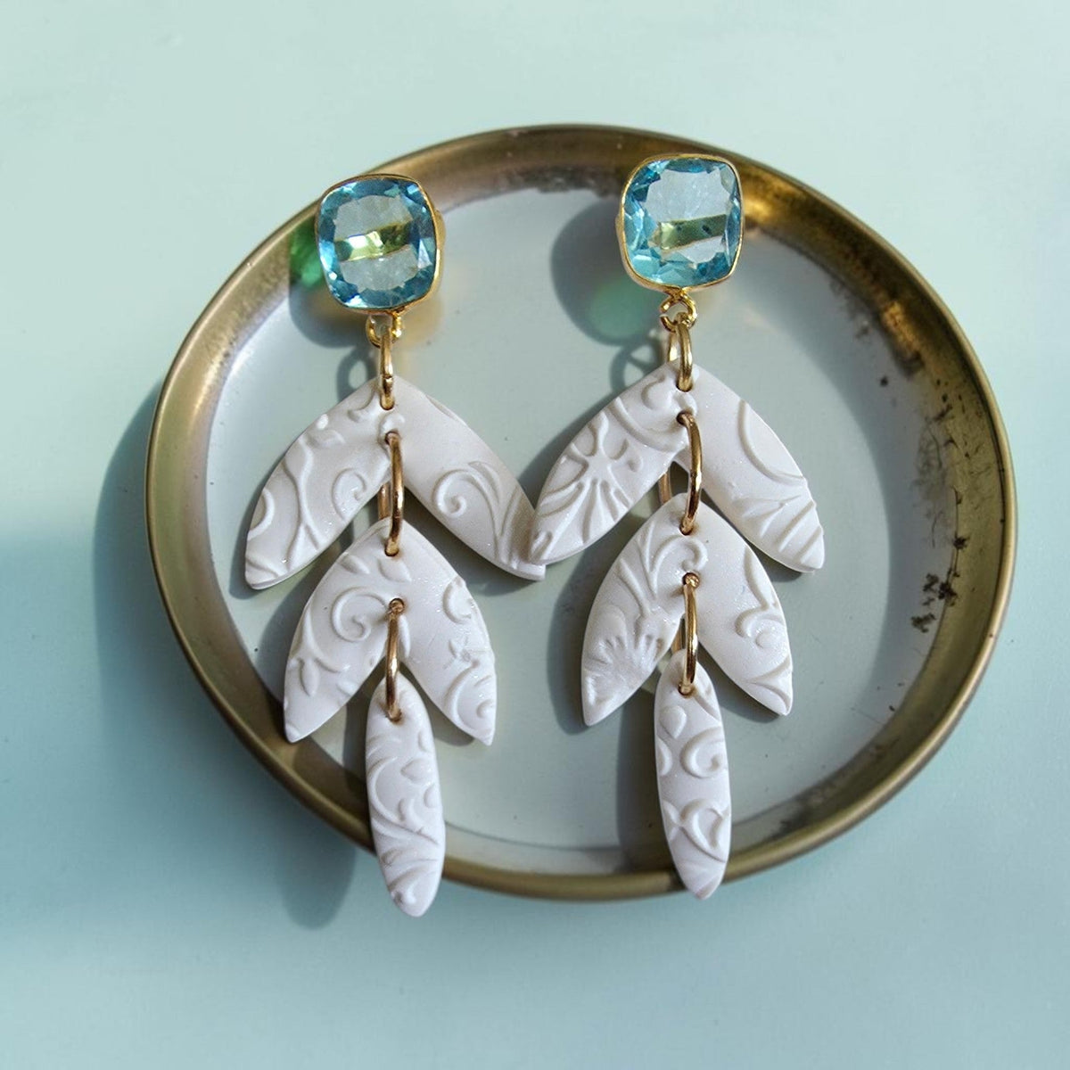 White polymer clay flower cluster hoop earrings with crystal-studded silver hoops