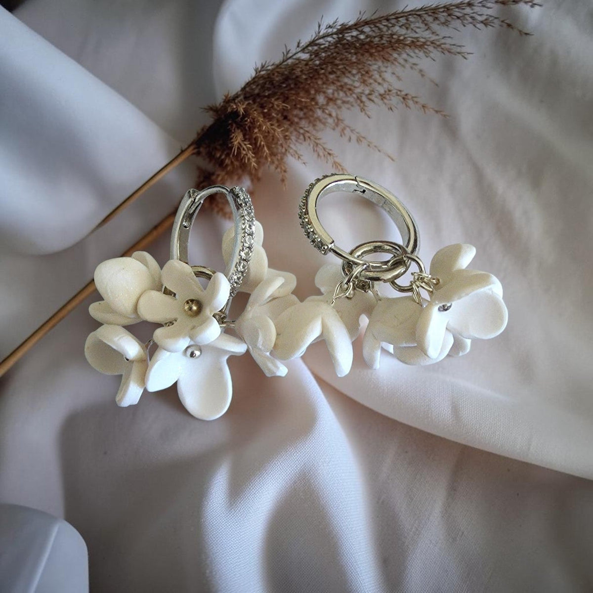 White embossed leaf cascade polymer clay earrings with aqua crystal gold studs