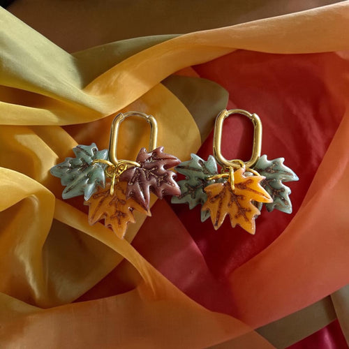 Handmade autumn leaf cluster polymer clay earrings on silver hoops
